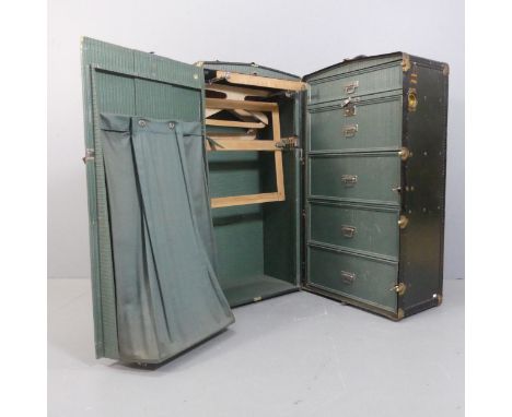 An early 20th century Oshkosh steamer wardrobe trunk, the interior fitted with hanging on one side and drawers on the other, 