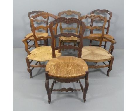A matched set of French oak rush-seated ladder-back dining chairs. (4+2).