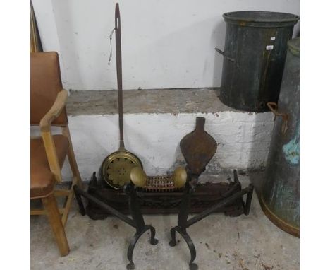 An antique cast iron fire surround, width 89cm, height 17cm, depth 28cm, a pair of wrought iron fire dogs, a pair of bellows,