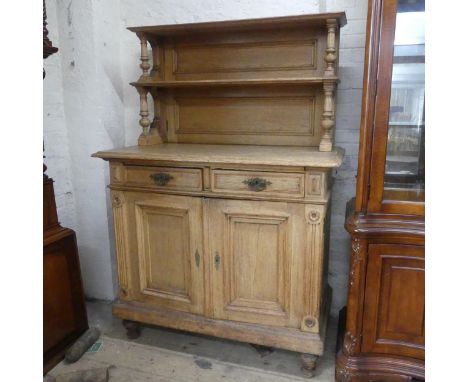 An antique oak sideboard, with raised back, two drawers and two cupboard doors. Width 118cm, height 170cm, depth 62cm.Front r