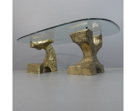 A rare mid-century brutalist bronze and glass coffee table, the rounded rectangular bevelled glass top on abstract sculptural