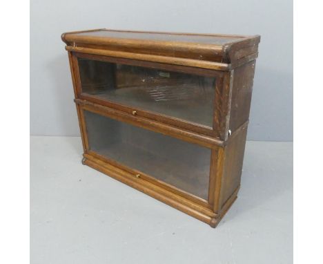 An Early 20th century oak Globe-Wernicke modular two-shelf bookcase, with maker's labels. Width 87cm, height 72cm, depth 27cm