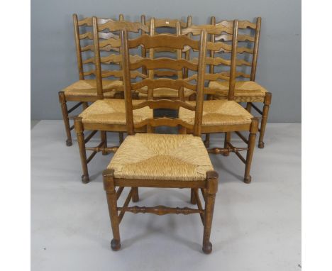 A six Lancashire oak rush-seated ladder-back dining chairs.