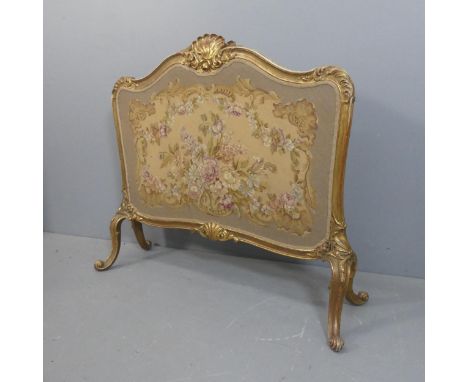 A French gilt painted firescreen with needlepoint upholstered panel, carved decoration and cabriole legs. Width 115cm, height