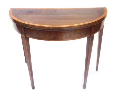 A George III plum pudding mahogany satinwood and tulipwood cross banded demi lune card table, on square tapering legs, 74cm h