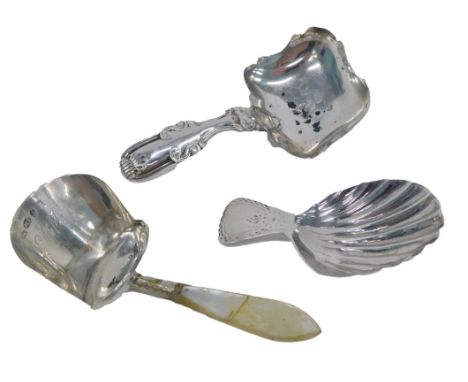 A George III silver tea caddy spoon, with shell shaped bowl, London 1909, and two others. (3) 
