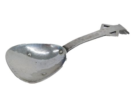 An Arts and Crafts hammered silver caddy spoon, with plain arm, with pierced sides and tapering end, by N Aldridge, Birmingha