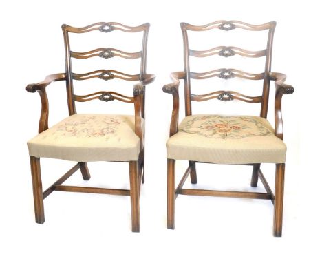 A pair of mahogany ladder back elbow chairs, each with woolwork upholstery, on channelled legs. 