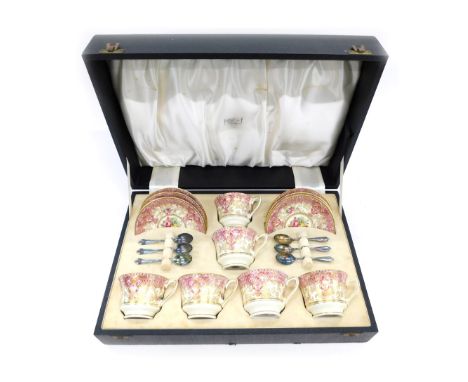 A Royal Worcester porcelain coffee service, decorated centrally with flowers, within elaborate puce and gilt borders, printed