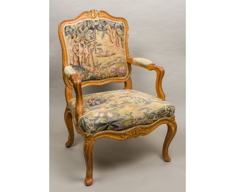 A late 19th century French tapestry covered open armchairThe carved top rail with gilt and red heightening above the tapestry