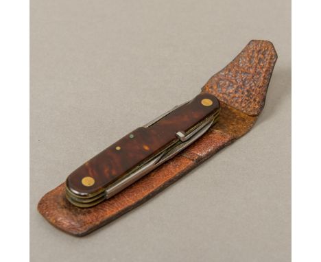 A vintage Bonsa Solingen folding multi-tooled pocket knifeOf typical form, with faux tortoiseshell handle, housed in a pig sk