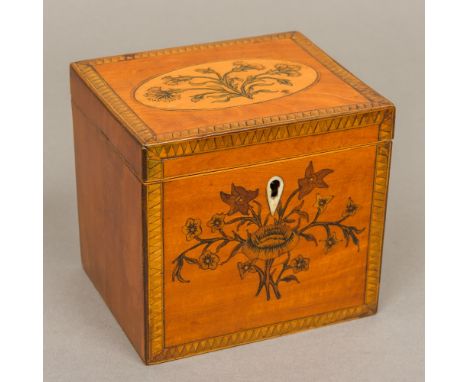 A late George III marquetry inlaid satinwood tea caddy Of rectangular section, the hinged cover and front with floral inlay w