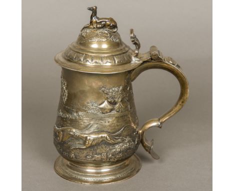 A George II silver tankard, hallmarked London 1747, maker's mark of JG RGOf lidded waisted baluster form with later embossed 