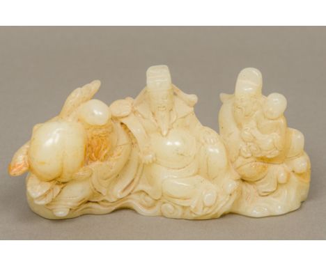 A Chinese carved mutton fat jade brush restOf figural form.  16.5 cm long.  CONDITION REPORTS: Generally in good condition, s