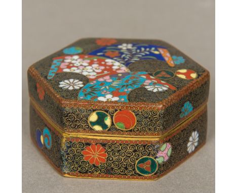 A late 19th/early 20th century Chinese cloisonne box Of hexagonal form, with removable lid decorated with various floral pane