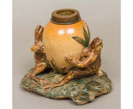 A English stoneware pottery oil lamp base, in the style of George Tinworth (1843-1913) BritishThe reservoir supported and fla