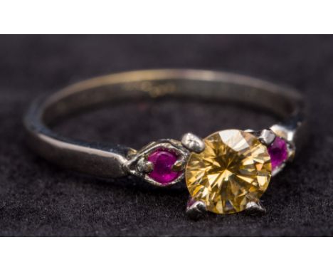 A 10 ct white gold yellow diamond and ruby ring The central yellow diamond approximately 0.90 carat.  CONDITION REPORTS: Gene