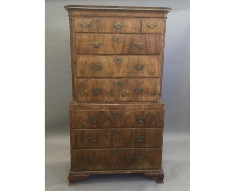 An 18th century walnut chest on chestThe moulded canted rectangular top above an arrangement of three over three drawers with