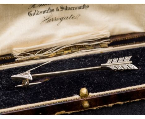An unmarked and diamond set bar broochOf arrow form.  6 cm long.  CONDITION REPORTS: Generally in good condition, some genera