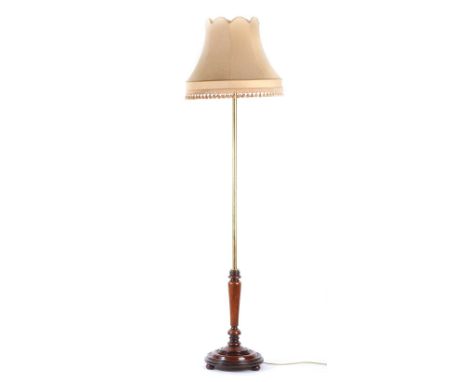 BRASS STANDARD LAMP & SHADE WITH A TURNED MAHOGANY BASE ON BUN FEET  - - HEIGHT 66 INCHES X BASE DIAMETER 14 INCHES