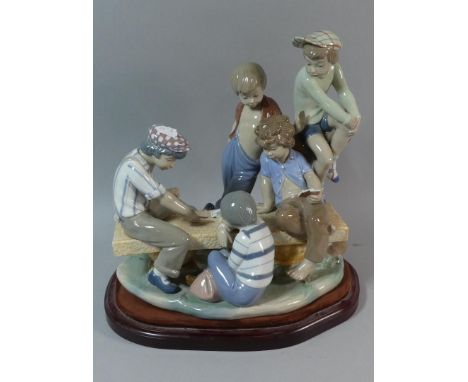 A Large Nao Figure Group, Five Boys Playing Cards on Wooden Plinth, 34cm Long 