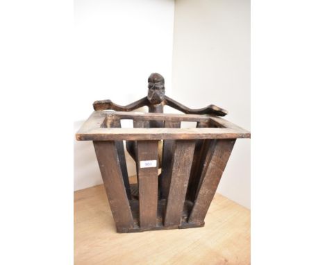 An unusual carved wooden tribal souvenier newspaper rack having Papua New Guinea figure, h38cm