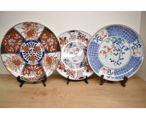A Japanese porcelain charger decorated with tree in full blossom and blue and white geometrical patterns, w31cm, sold togethe
