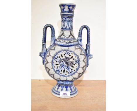 A German Rhenish pottery moon flask, of typical form with bands of repeating motifs, central pierced decoration enclosing a d