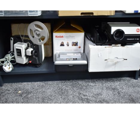 A Kodak EasyShare printer dock, a Plus-O-Matic Super 8 film projector and a Leica PRADOVIT P150 slide projector
