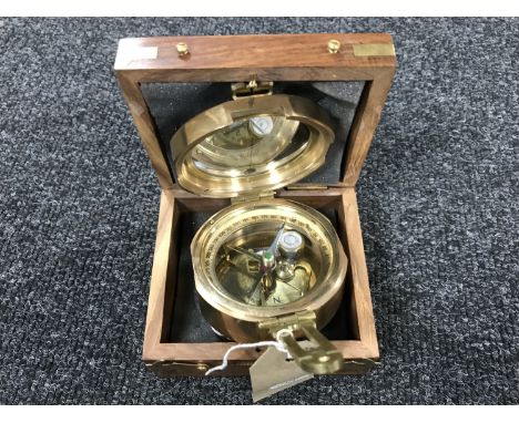 A brass nautical compass in fitted box
