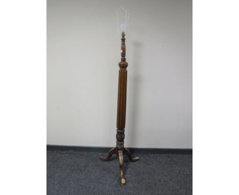 An antique mahogany standard lamp 