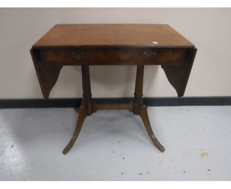 A walnut flap sided sofa table, fitted two drawers 