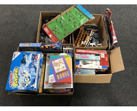 Four boxes of assorted board games, jigsaws, Scalectrix track, vintage tin plate Chad Valley soccer stadium 