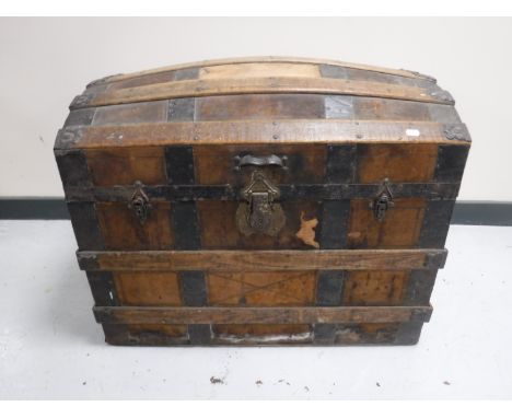 An antique iron bound domed shipping trunk 