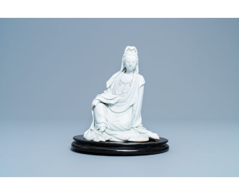 A Chinese blanc de Chine figure of Guanyin, seal mark, 19/20th C.H.: 20 cm (the figure excl. stand)