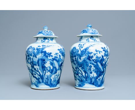 A pair of Chinese blue and white baluster vases and covers with birds in a rocky setting, KangxiH.: 40 cm
