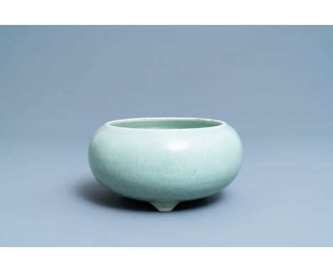 A Chinese celadon-glazed tripod censer with incised underglaze design, KangxiDia.: 26 cm (outer) - H.: 13 cm