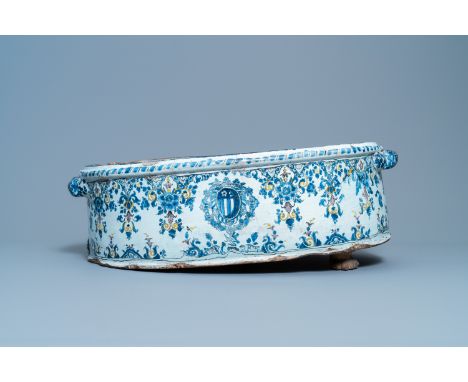 A large oval polychrome French faience armorial basin, Rouen or Paris, 18th C.Dim.: 68,5 x 47 x 26 cm