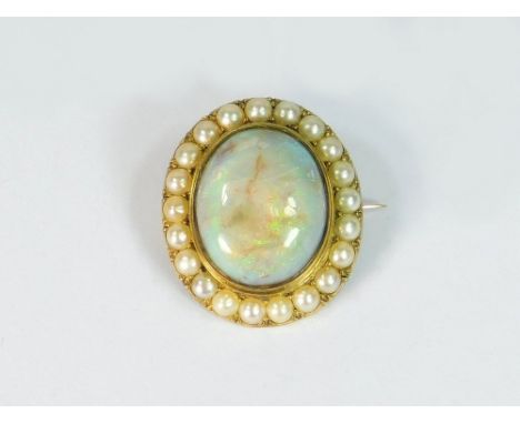 OPAL BROOCH. A Victorian 18ct. gold (unstamped) brooch, set a cabochon opal of approx. 15ct., within a natural half-pearl bor