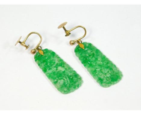 JADE EARRINGS. A pair of fine Chinese green jade, pierced & carved pendant earrings on 9ct. gold screw fittings. Length of dr