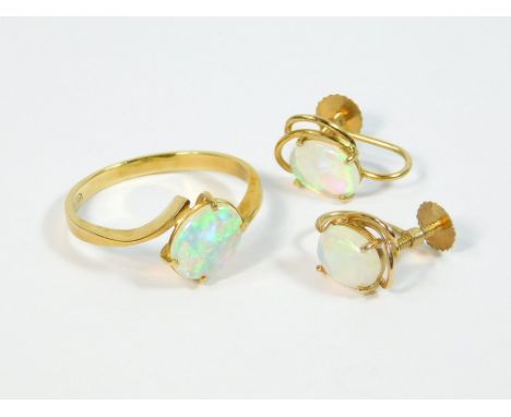 OPAL RING ETC. An 18ct. gold hand made ring set an oval opal stone. Size R. Also, a similar pair of opal earrings set in 10k.