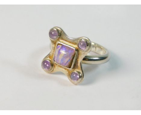 OPAL RING. A hand made silver ring set a central opal & four cabouchon amethysts. Size K.  Please note that all items in this