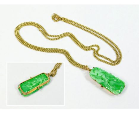 JADE PENDANT. A carved & pierced green Chinese jade pendant set in a yellow metal frame & hung on a 9ct. gold chain. Length o