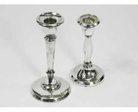 CANDLESTICKS. A silver candlestick with tapering column, Birmingham 1919. Height 15cm. Also, one other smaller silver candles