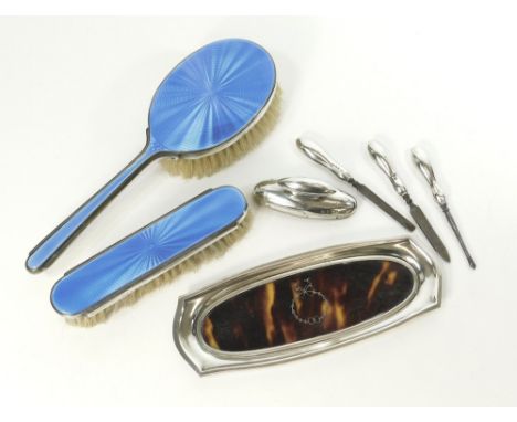 BRUSHES ETC. Two 1930's silver mounted & enamelled brushes by Mappin & Webb, a silver & tortoiseshell pin tray & four silver 