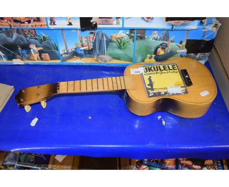 A ukelele with instruction manual by Jim Dunlop