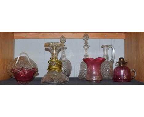 A Waterford style glass mushroom lamp, three decanters, a cranberry glass oil lamp, and a dish (6).  Waterford lamp with shad
