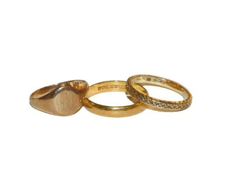 A 22 carat gold band ring, finger size R, a 9 carat gold textured band ring, finger size Q, and a signet ring, finger size M.