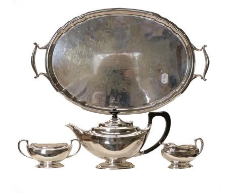 A silver three-piece tea service marked for London and bearing a monogram, gross weight 999 grams, together with a silver pla