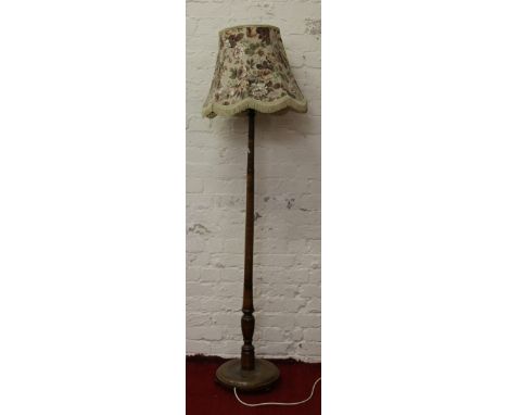 A turned oak standard lamp.